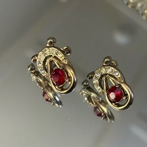 Vintage-style gold-tone clip on earrings with a central red gemstone